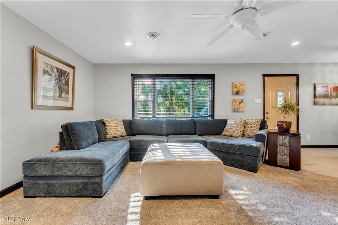 7479 Macedonia Road Bedford, OH 44146 - Photo 26 of 42 Carpeted living room with ceiling fan