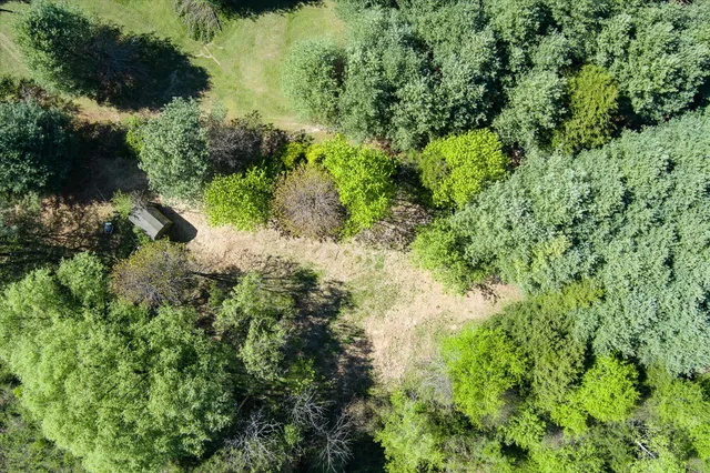 an aerial view of a house with a yard