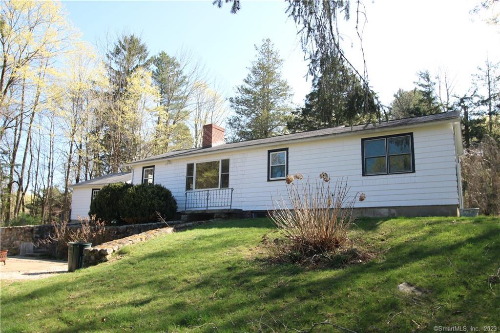 618 South Plains Road Litchfield, CT 06759 - Photo 1 of 1 a backyard of a house with wooden fence and plants