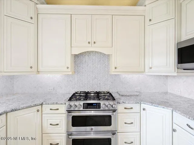 a view of a swimming pool with a yard and palm trees
