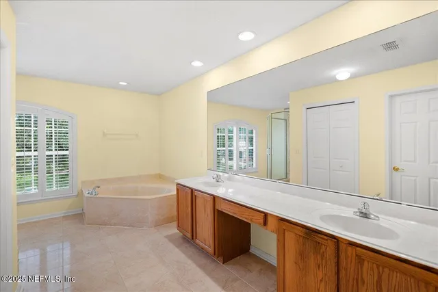a view of a house with a yard and potted plants
