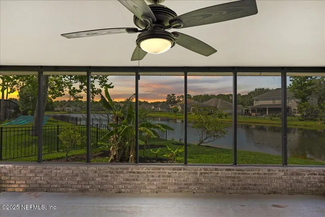 an empty room with a window and a ceiling fan