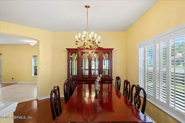 a view of a porch with a floor to ceiling window in a yard