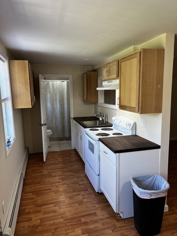 a large kitchen with a stove and a sink
