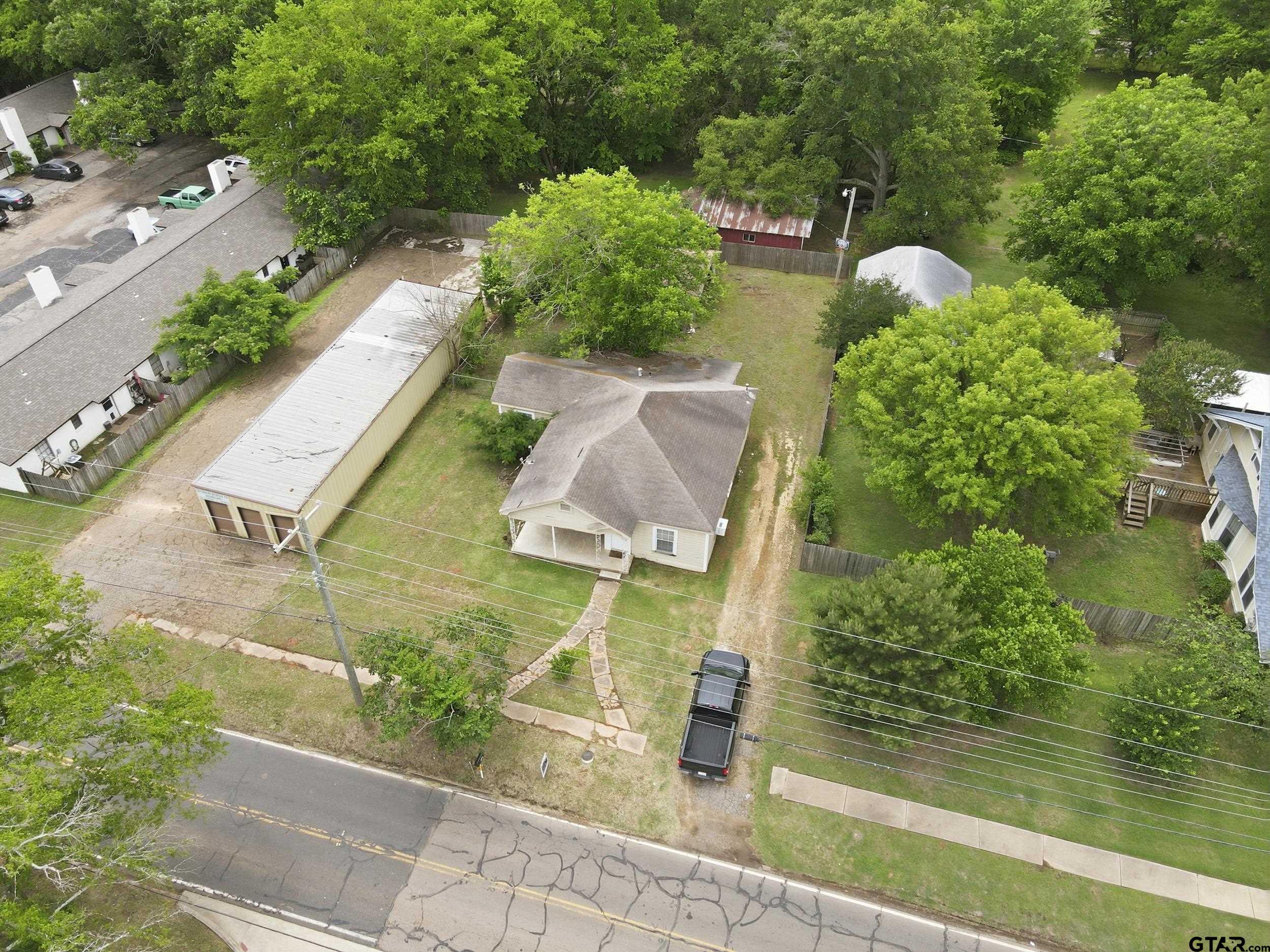405 Rusk Street Pittsburg, TX 75686 - Photo 25 of 33 an aerial view of residential house with outdoor space and swimming pool