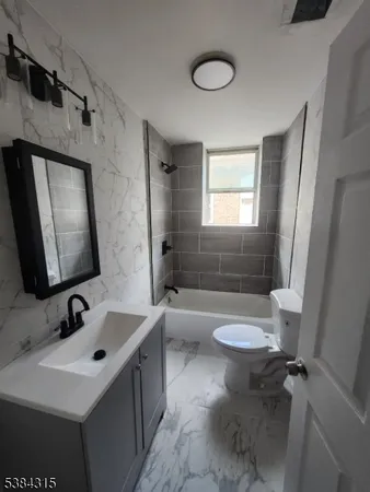 a bathroom with a sink a toilet and mirror