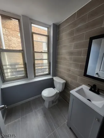 a bathroom with a toilet sink and window
