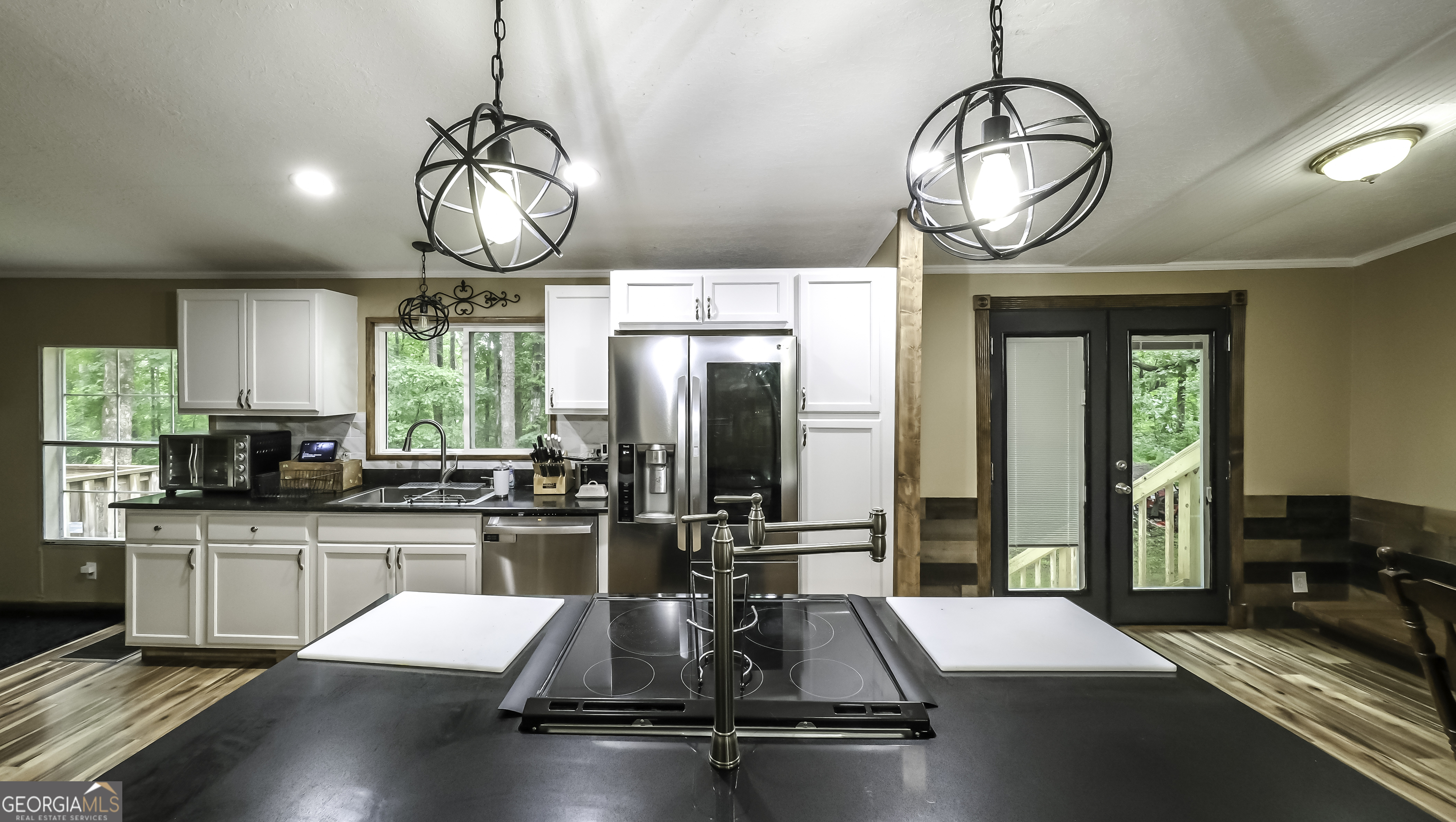 91 Holder Road Temple, GA 30179 - Photo 7 of 40 a view of a kitchen with kitchen island granite countertop wooden floor stainless steel appliances and a sink