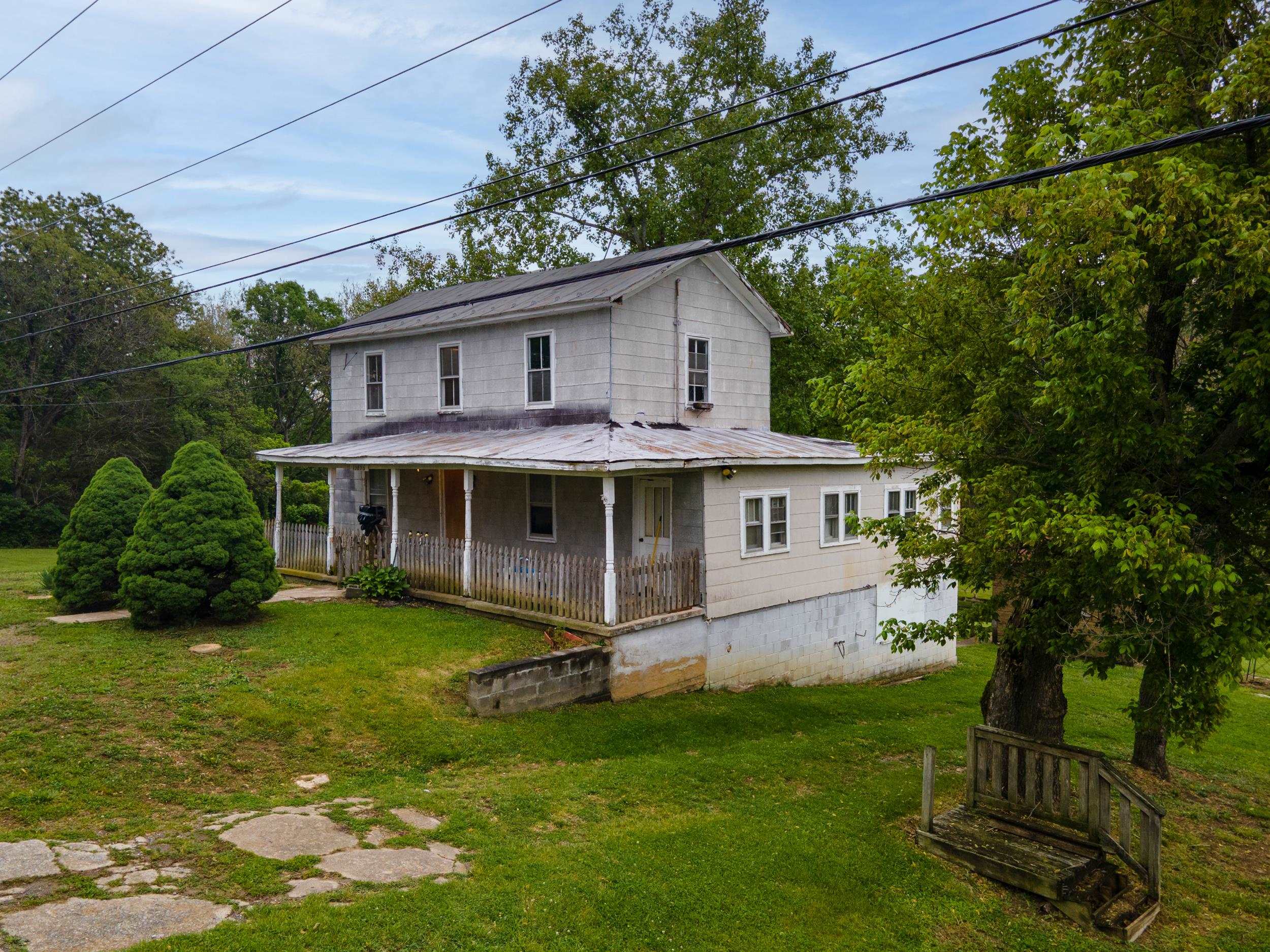 13896 Rockingham Pike Elkton, VA 22827 - Photo 54 of 60 a view of a house with a yard potted plants and large tree