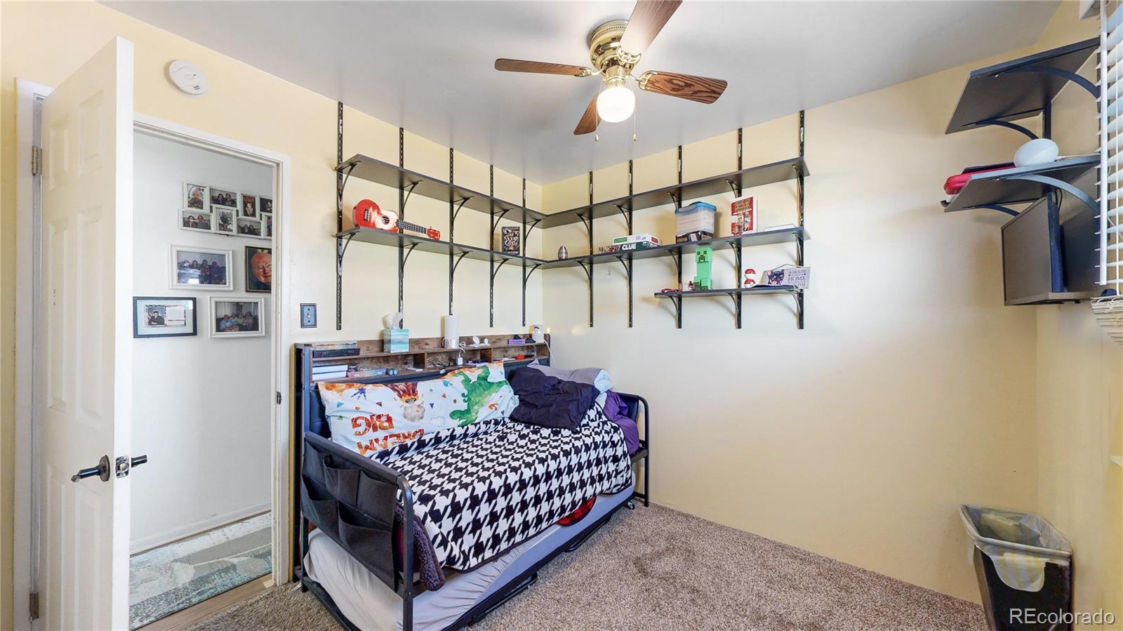 1960 Rowena Street Thornton, CO 80229 - Photo 13 of 48 a bedroom with a bed and a chandelier