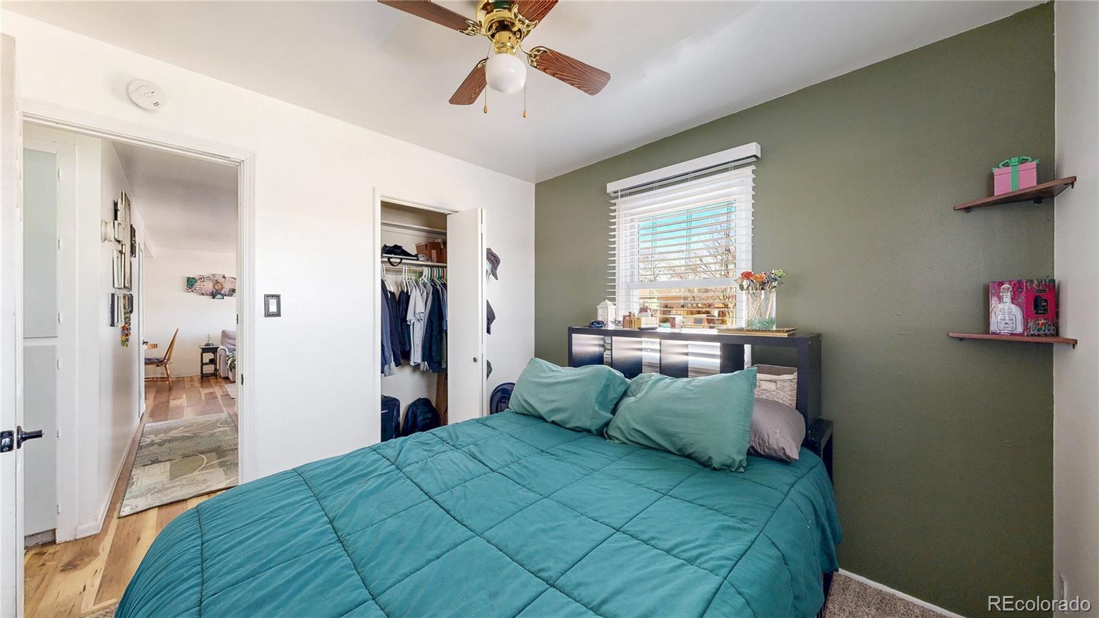 1960 Rowena Street Thornton, CO 80229 - Photo 15 of 48 a bedroom with a bed and wooden floor