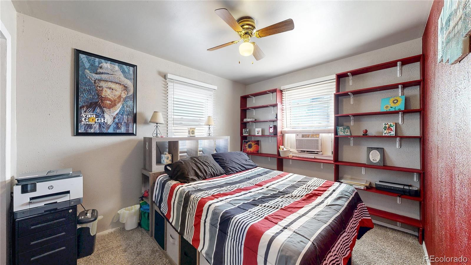 1960 Rowena Street Thornton, CO 80229 - Photo 17 of 48 a bedroom with a bed a dresser and a book shelf