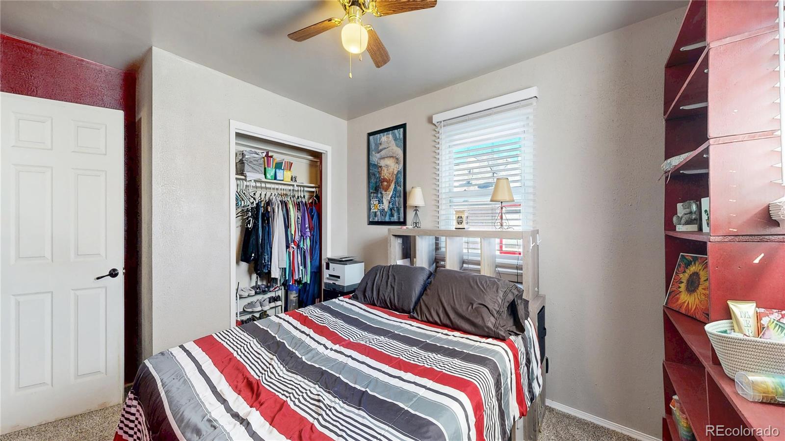 1960 Rowena Street Thornton, CO 80229 - Photo 18 of 48 a bedroom with bed and a chandelier