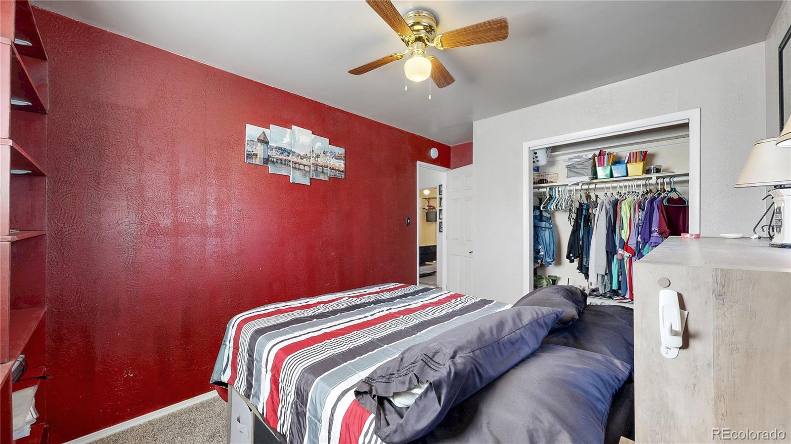 1960 Rowena Street Thornton, CO 80229 - Photo 19 of 48 a bedroom with a bed and a chandelier