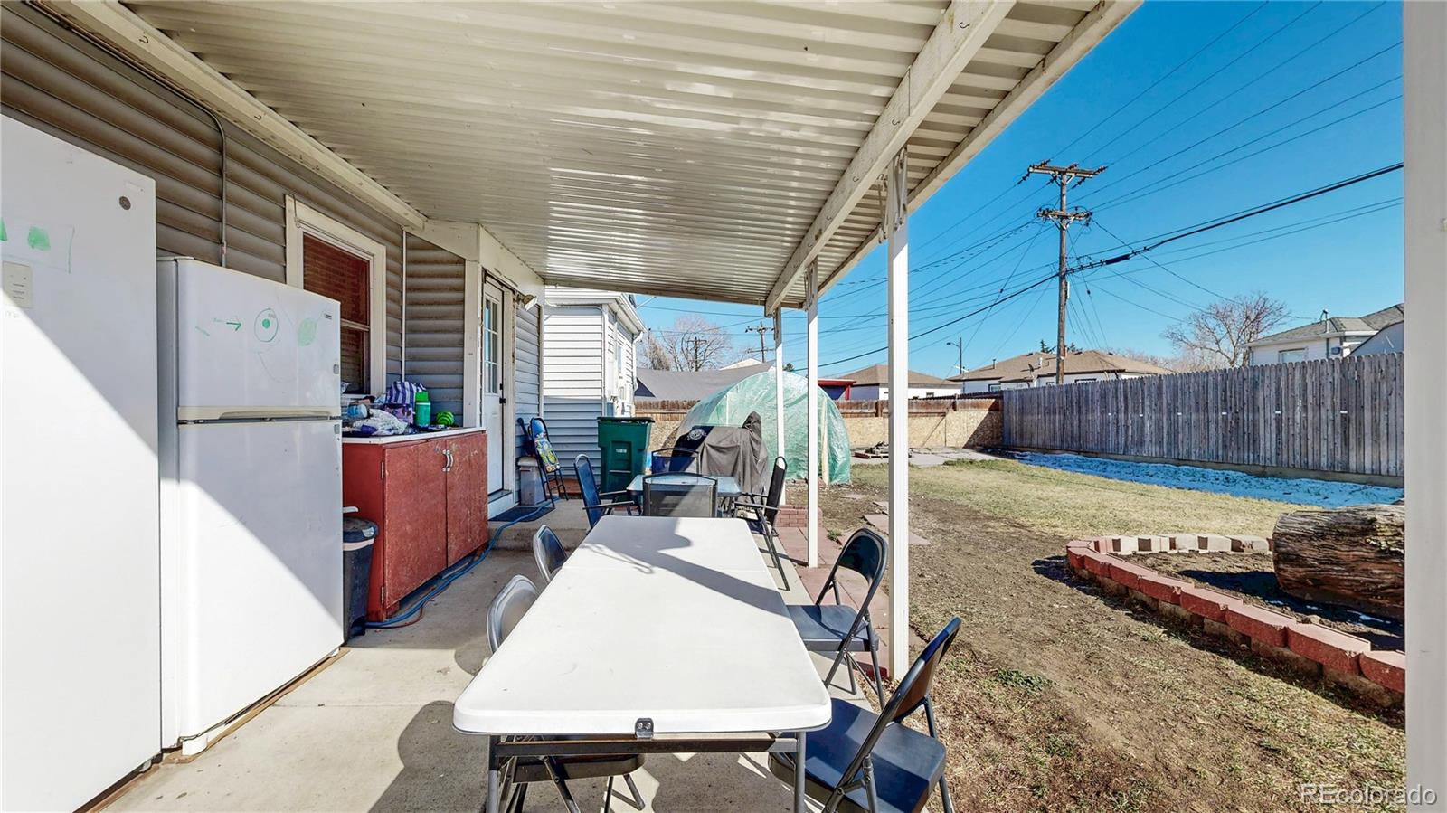 1960 Rowena Street Thornton, CO 80229 - Photo 25 of 48 a view of a patio with table and chairs a barbeque with wooden floor