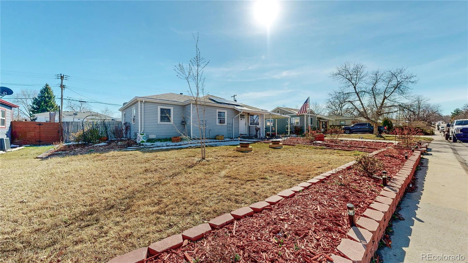 1960 Rowena Street Thornton, CO 80229 - Photo 28 of 48 a front view of a house with a yard