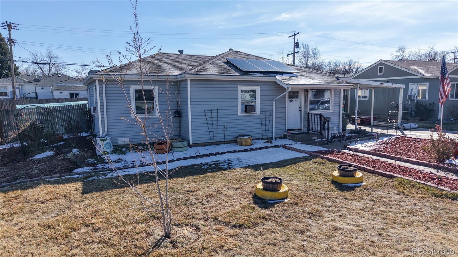 1960 Rowena Street Thornton, CO 80229 - Photo 3 of 48 a front view of a house with garden