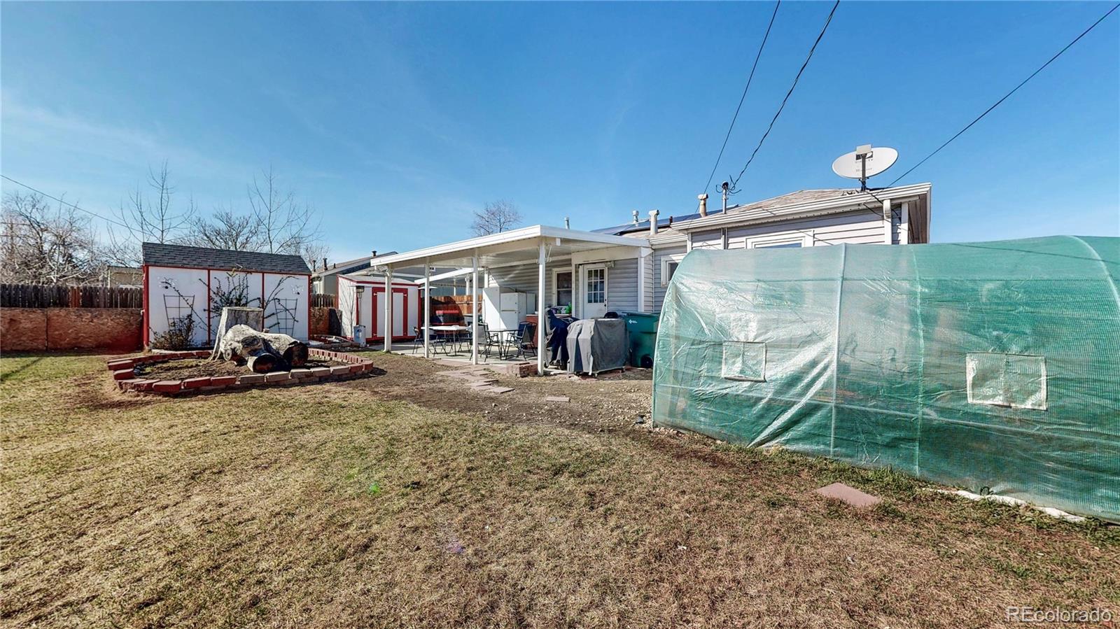 1960 Rowena Street Thornton, CO 80229 - Photo 34 of 48 a view of a house with backyard porch and sitting area