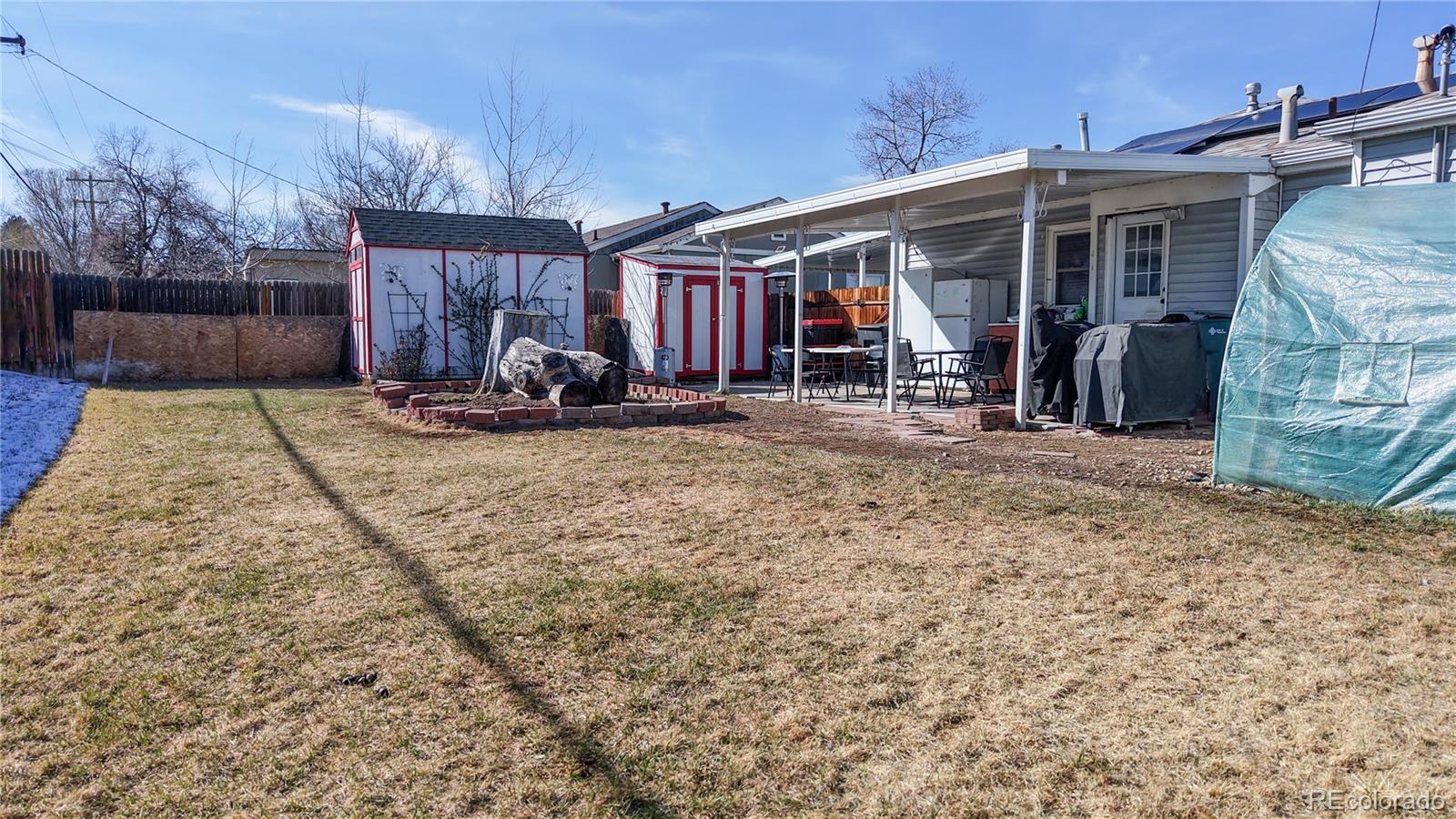 1960 Rowena Street Thornton, CO 80229 - Photo 37 of 48 a view of a house with patio area and wooden fence