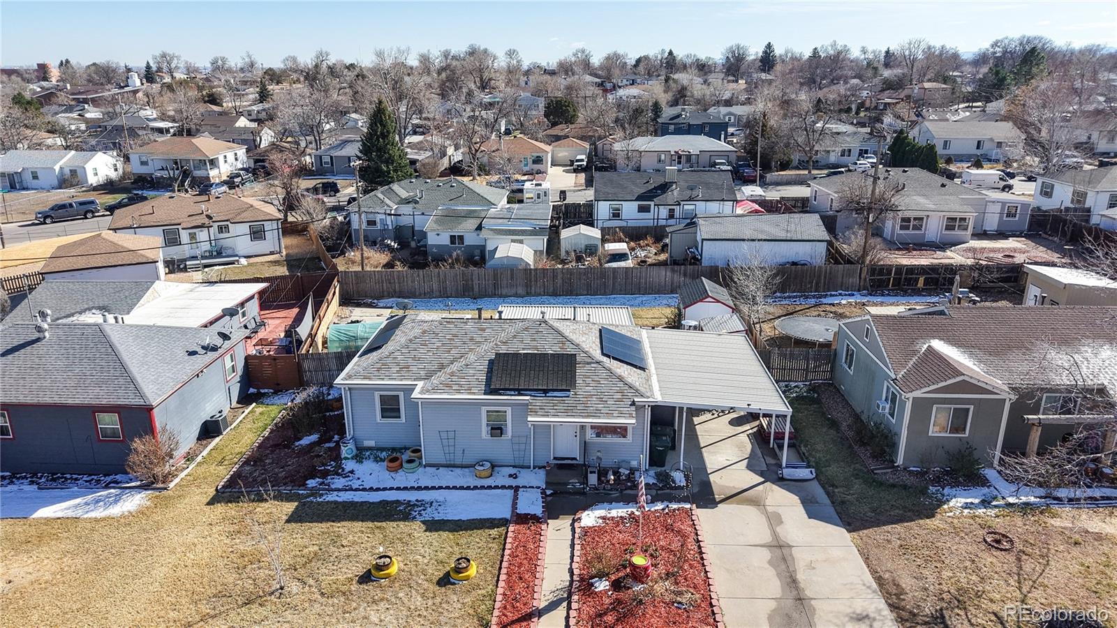 1960 Rowena Street Thornton, CO 80229 - Photo 40 of 48 an aerial view of a house with a yard covered with snow in front of it