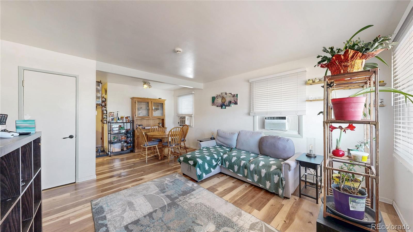 1960 Rowena Street Thornton, CO 80229 - Photo 4 of 48 a living room with furniture and a wooden floor