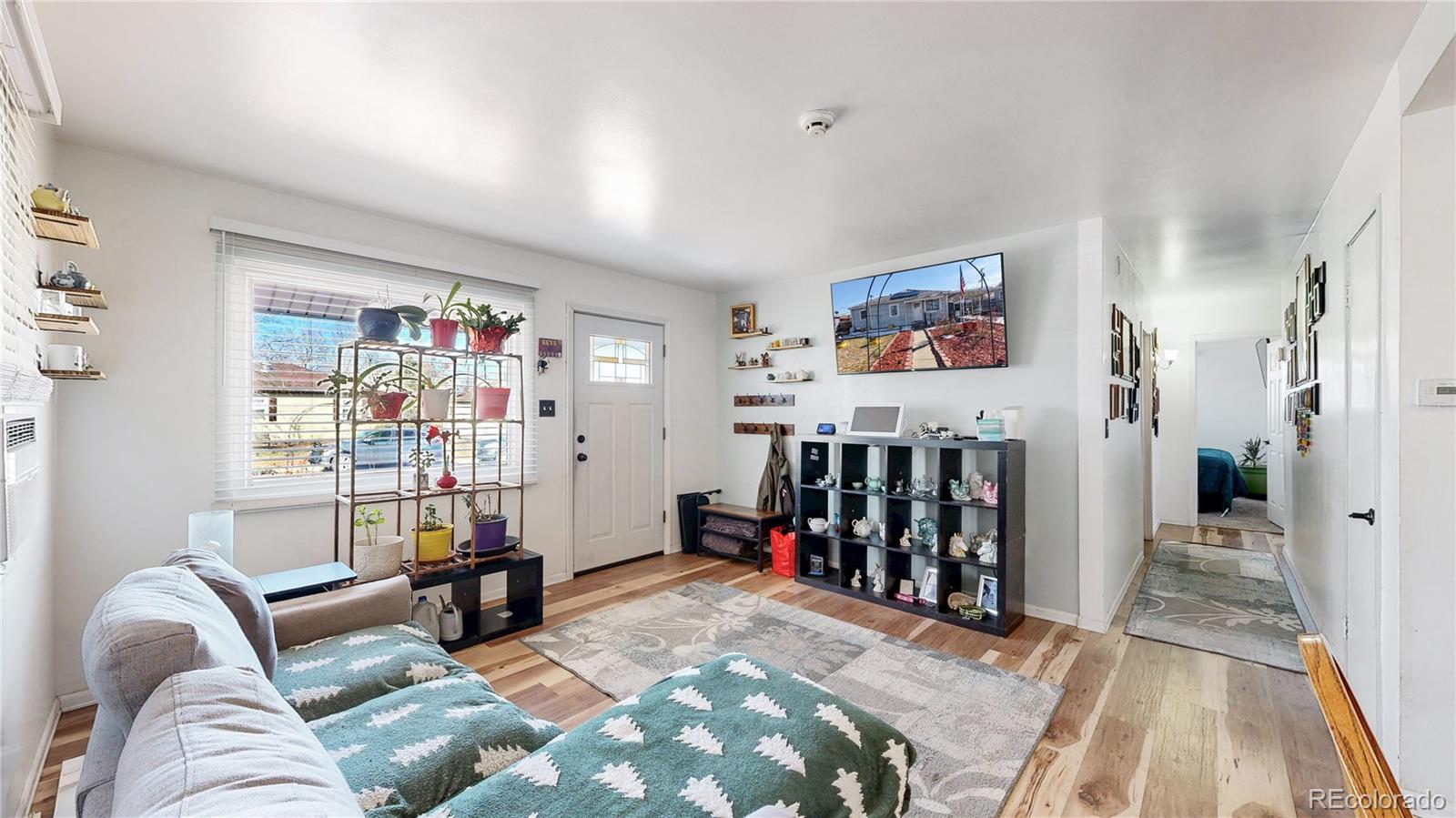 1960 Rowena Street Thornton, CO 80229 - Photo 5 of 48 a bed room with a bed and a book shelf
