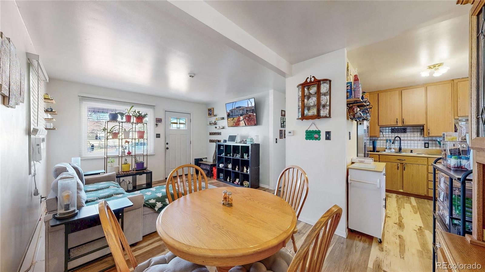 1960 Rowena Street Thornton, CO 80229 - Photo 7 of 48 a dining room with furniture a rug and wooden floor