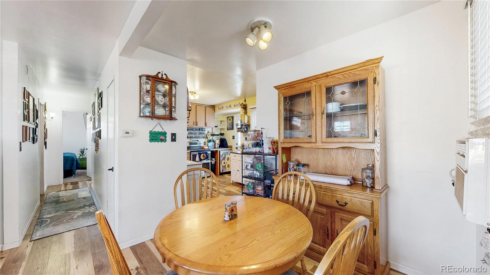 1960 Rowena Street Thornton, CO 80229 - Photo 8 of 48 a dining room with furniture a rug and wooden floor