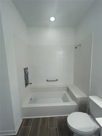 a view of a room with a large window and sitting area