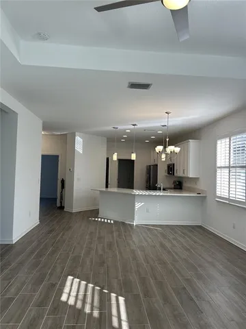 a view of kitchen with sink and wooden floor