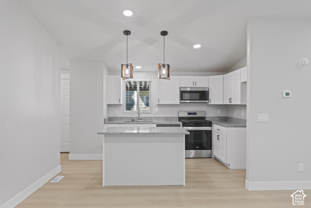 96 Barrington Way Layton, UT 84041 - Photo 6 of 18 Kitchen featuring white cabinetry, stainless steel appliances, granite-style countertops, wood-finish flooring, and recessed lighting