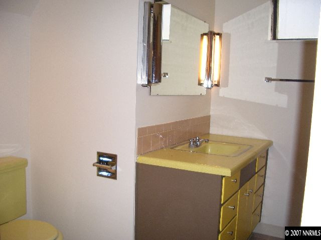 765 Belgrave Avenue Reno, NV 89502 - Photo 7 of 9 a bathroom with a granite countertop sink and a mirror