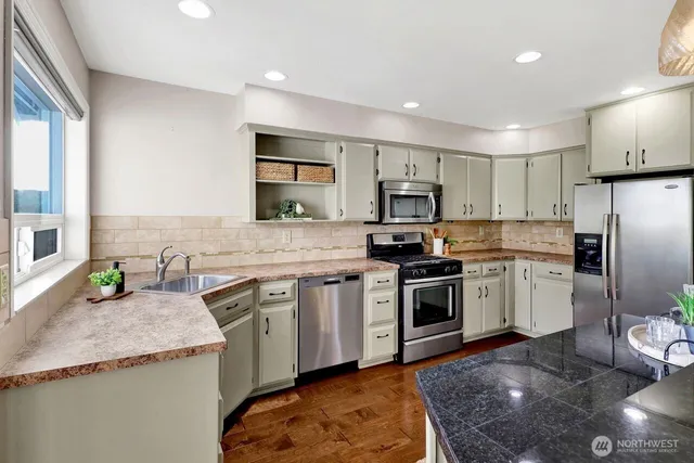 a kitchen with a sink stove and refrigerator