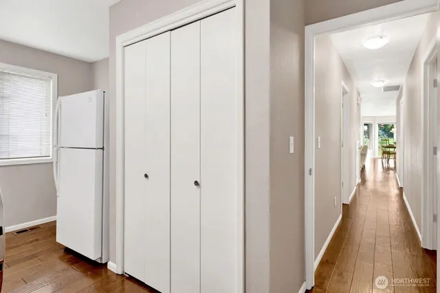 a view of a hallway with wooden floor