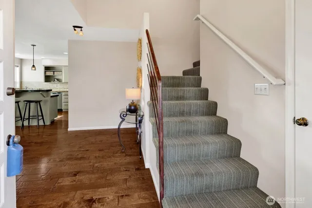 a view of entryway and hall with wooden floor