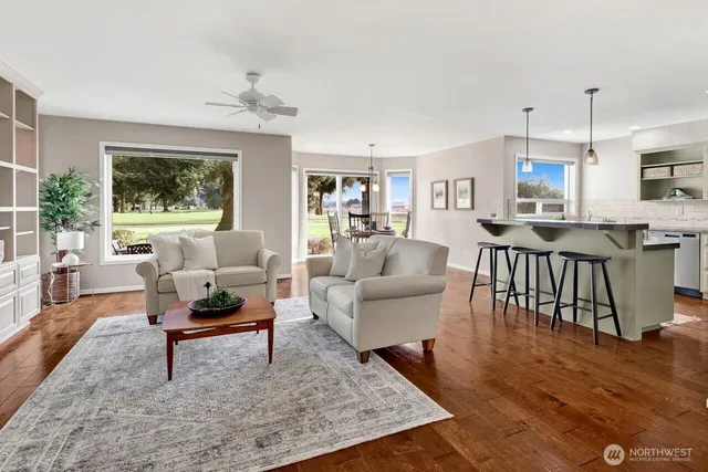 a living room with fireplace furniture and a table
