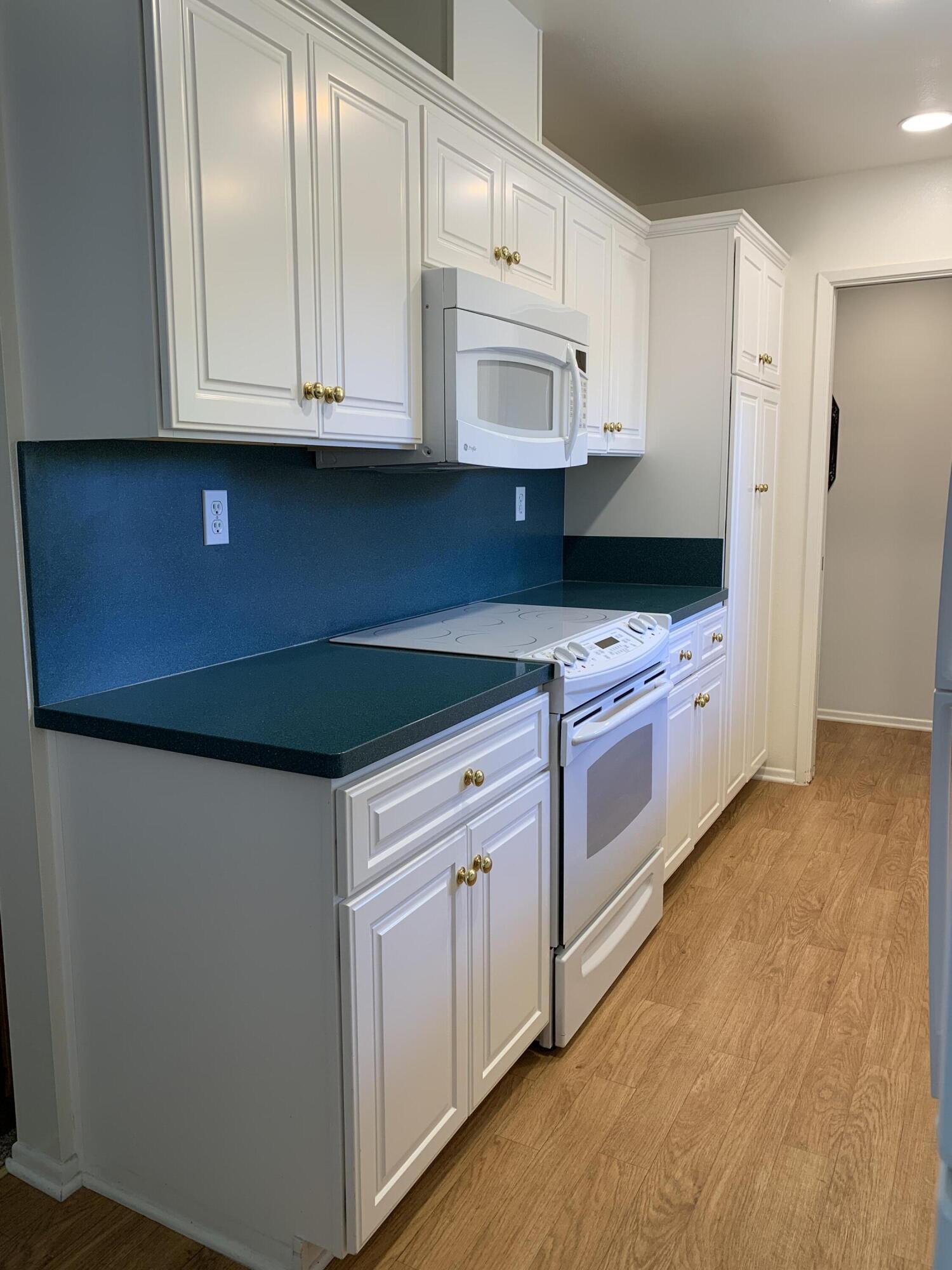277 Forest Drive Goleta, CA 93117 - Photo 6 of 18 a kitchen with granite countertop white cabinets and white appliances