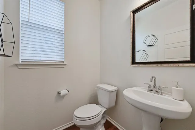 a white toilet sitting next to a bathroom sink