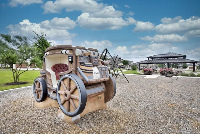 a car parked in front of a yard with green space