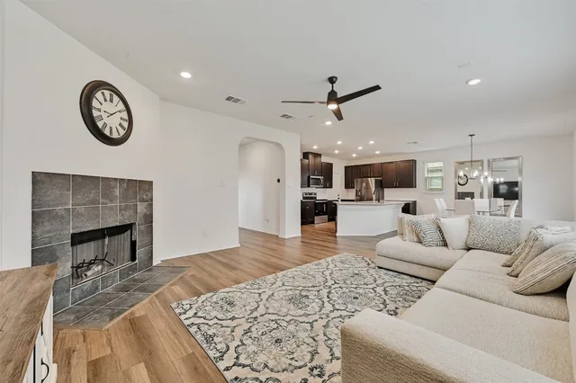 a living room with furniture and kitchen view