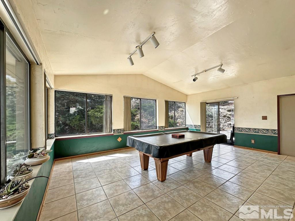 20595 Cooke Drive Reno, NV 89521 - Photo 12 of 32 a dining hall with couches a table and chairs with wooden floor