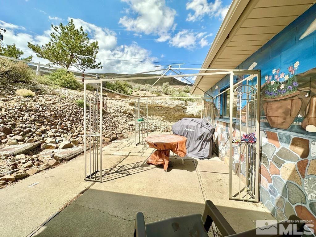 20595 Cooke Drive Reno, NV 89521 - Photo 28 of 32 a view of a patio with a table and chairs and potted plants