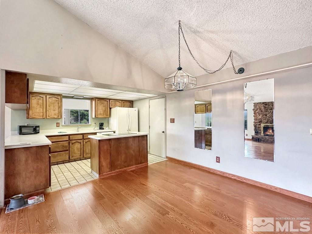 20595 Cooke Drive Reno, NV 89521 - Photo 8 of 32 a large kitchen with kitchen island a large counter space wooden floor and stainless steel appliances