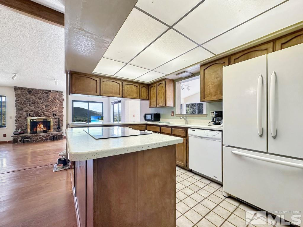 20595 Cooke Drive Reno, NV 89521 - Photo 9 of 32 a kitchen with stainless steel appliances granite countertop a sink a stove and a refrigerator