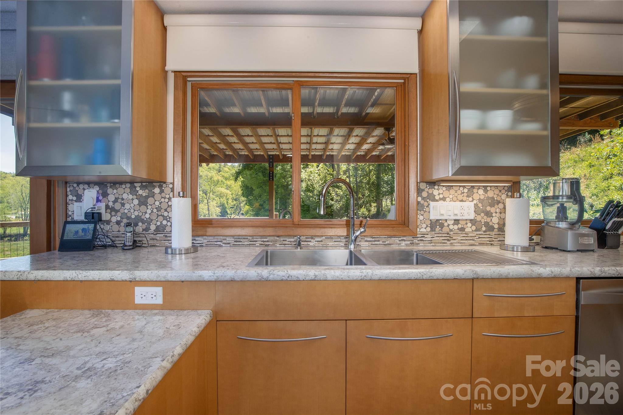 93 Franklin Crest Road Spruce Pine, NC 28777 - Photo 28 of 47 a kitchen with granite countertop a sink and a window