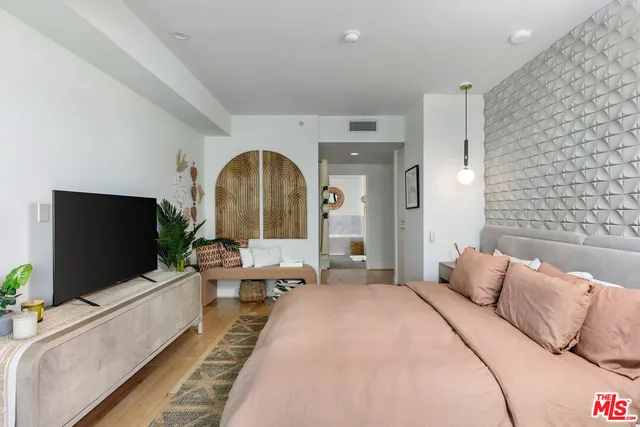 a living room with a flat screen tv and a couch