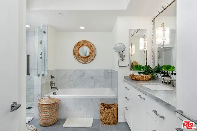 a bathroom with a sink a mirror and a bathtub