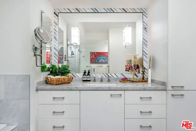 a bathroom with a sink a mirror and a bathtub