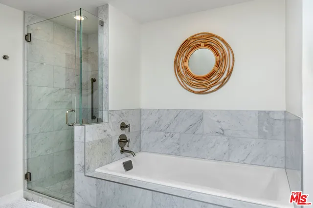 a bedroom with a bed table flowerpot and window