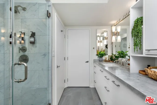 a bathroom with a shower and a sink